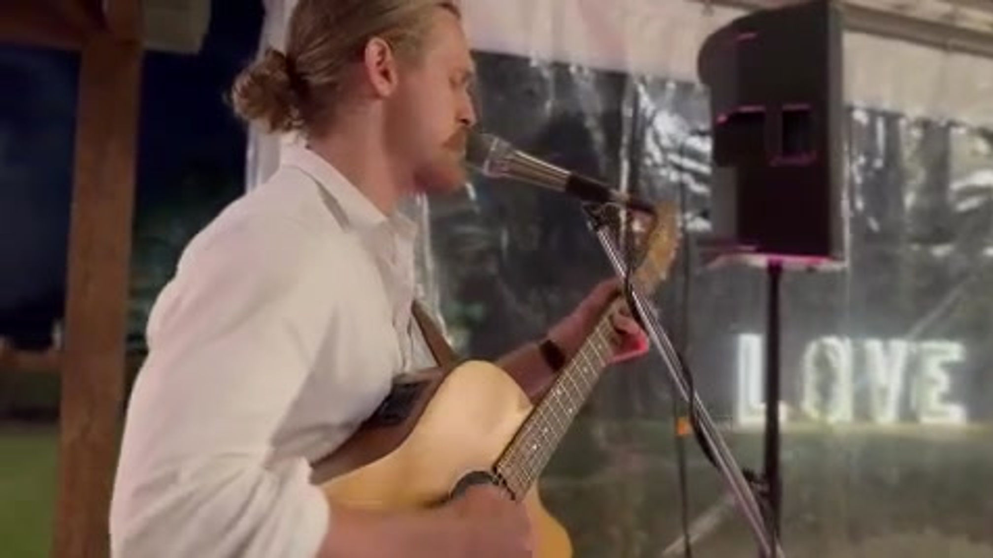 Oscar playing "Just the Way You Are" by Billy Joel at an outdoor wedding
